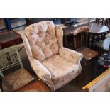 A floral upholstered buttoned wing back armchair