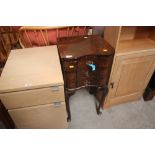 A walnut serpentine front bedside cabinet raised o