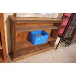 A stripped pine dwarf bookcase with adjustable she