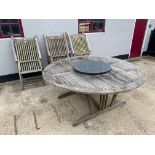 A large teak garden table fitted with a granite La