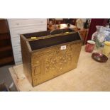 A decorative brass embossed magazine rack