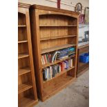 A large stripped pine open fronted bookcase
