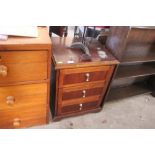 A mahogany bedside chest fitted three drawers