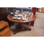 A 19th Century circular mahogany snap top dining t