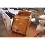 An Edwardian golden oak coal scuttle with brass ha