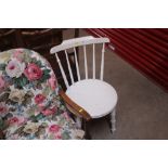 A white painted stick back kitchen chair