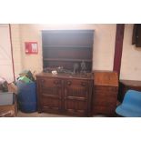 An oak dresser with shelved and boarded back, two