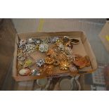 A box of costume brooches