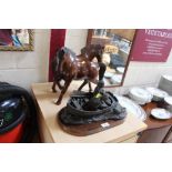Two carved hardwood model horses; and a Heredities