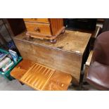 An Antique oak drop leaf dining table