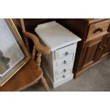 A white painted chest fitted four drawers