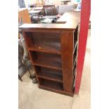 A stained pine open fronted corner bookcase