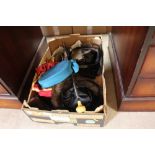 A box containing handbags, scarves and hats
