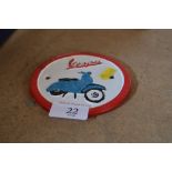 A reproduction cast iron Vespa advertising sign