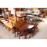 A reproduction mahogany circular extending dining