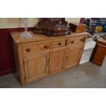 A stripped pine dresser, fitted three drawers and