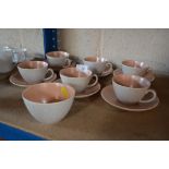 A collection of Poole twin tone teacups and saucer