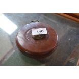 A leather cased tape measure