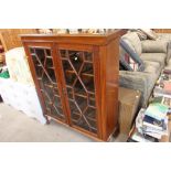 A mahogany and glazed bookcase raised on cabriole