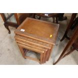 A nest of four carved hard wood occasional tables