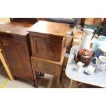 A mahogany two compartment drop front cupboard rai