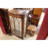 A mahogany bow front display cabinet raised on squ