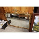 A gilt framed and bevelled edge wall mirror