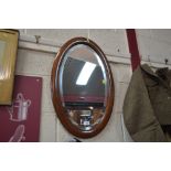 An Edwardian mahogany and inlaid oval mirror
