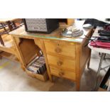 A stripped pine desk fitted three drawers