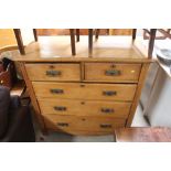 A golden oak chest, fitted two short over three lo