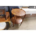 A reproduction walnut veneered two tier trolley