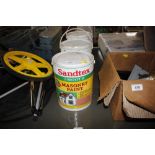 Three containers of Sandtex smooth masonry paint, a