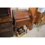 A walnut ladies writing bureau raised on ball and