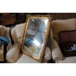 A gilt framed and bevelled edge wall mirror
