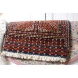 An approx. 2'9" x 2' patterned rug