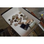 A box containing various coins and bank notes