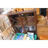 An oak and glazed bookcase, raised on cabriole sup