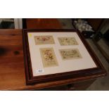 Four needlework postcards contained in one frame