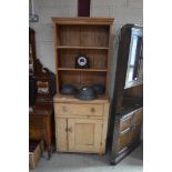 A small stripped pine kitchen dresser