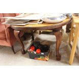 A mahogany dining table raised on cabriole support