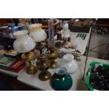 A collection of oil lamps and table lamps; a pair