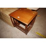 A nest of three teak occasional tables