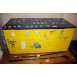 A blue and yellow painted toy chest