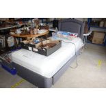 A single bed and mattress with headboard