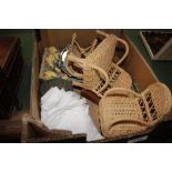 A box containing wicker dolls furniture and decora