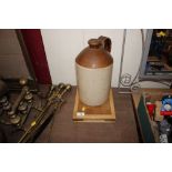 A wooden chopping board; and a stone glazed flagon