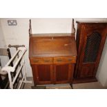 An oak bureau fitted two short drawers, interior f