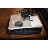 A Toshiba laptop with charger and carrying case -