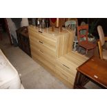 A beech effect four drawer chest and matching beds