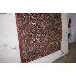 An approx. 9' x 4' floral patterned rug